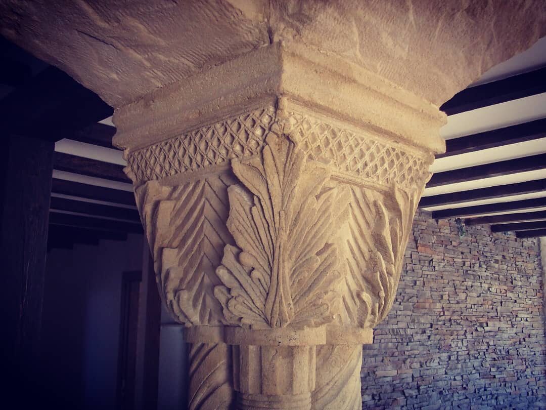 Hand-carved column capital with decorative motifs