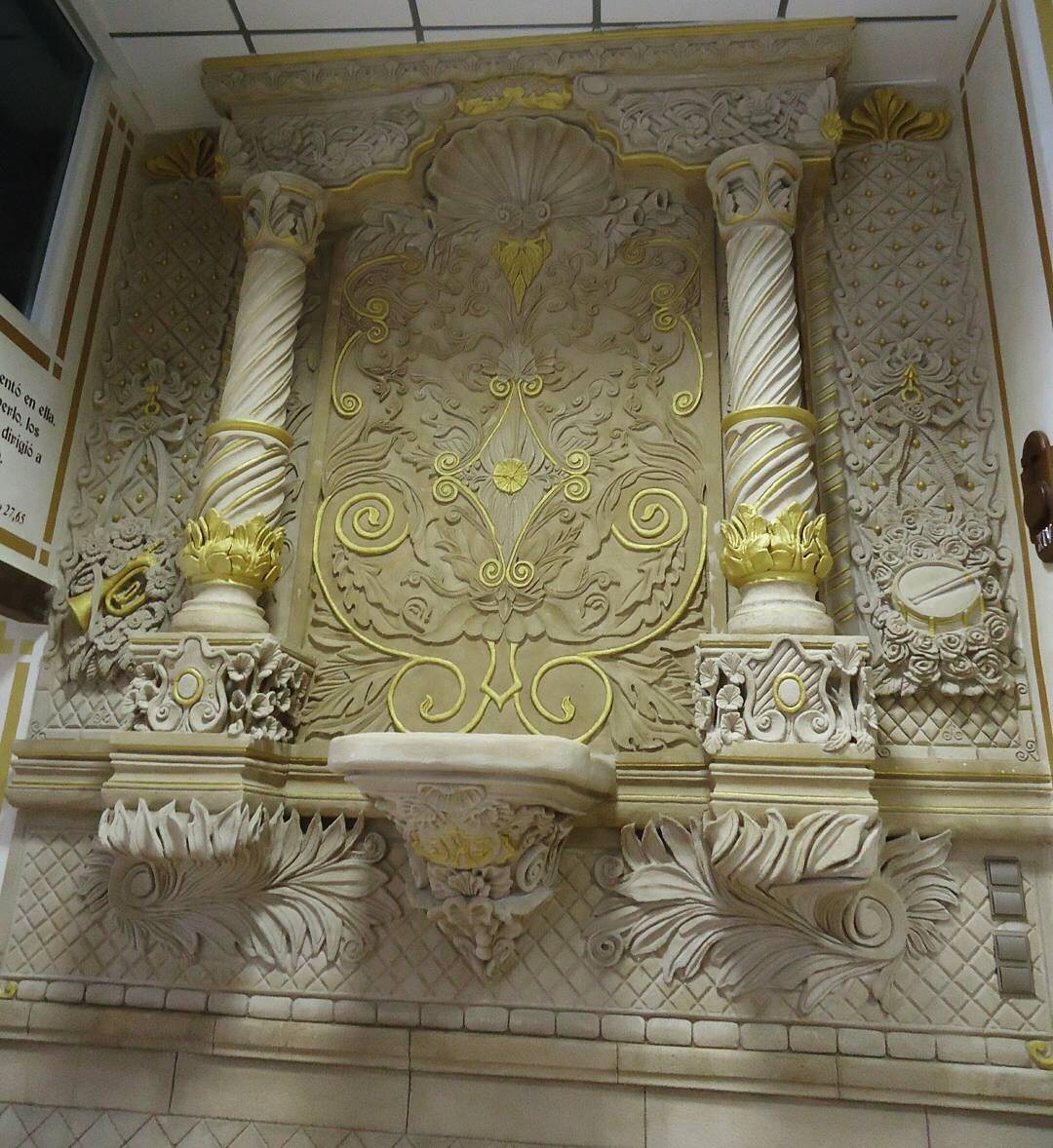 Ornate carved surface finished with gold detailing
