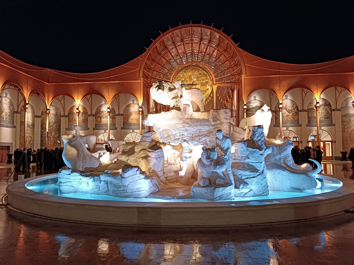 Illuminated white sculptural fountain inside an ornate domed hall at Pairi Daiza, Belgium