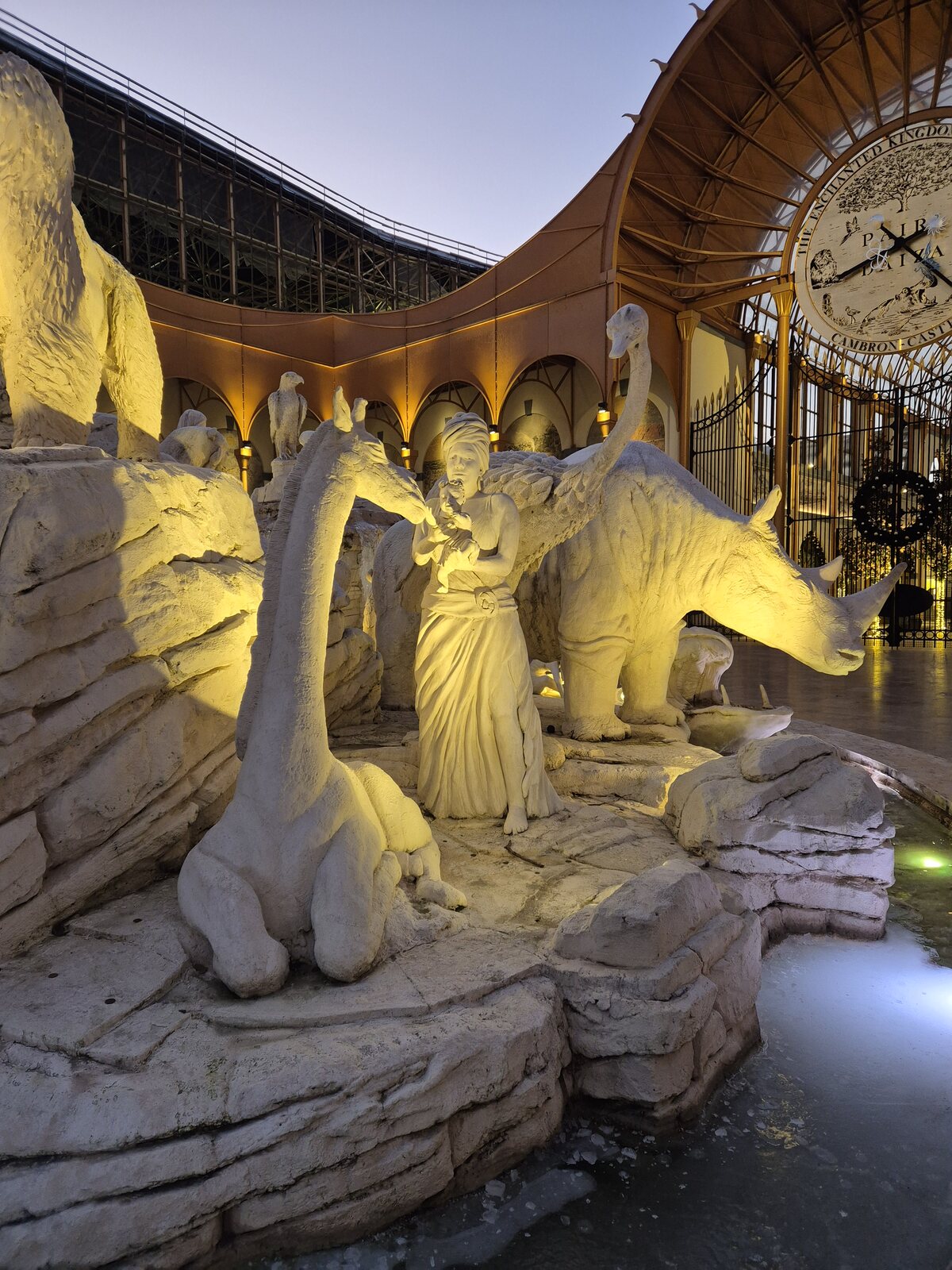 Gilded winged sculptures integrated into a themed ceiling at Pairi Daiza